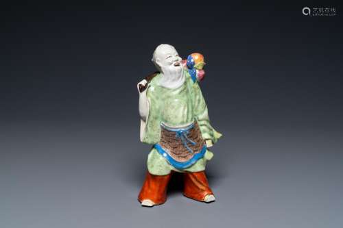Lot 1056: A CHINESE FAMILLE ROSE FIGURE OF AN IMMORTAL, QIAN...