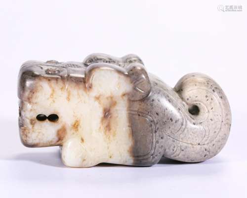 A Carved White and Russet Jade Beast Shang Dyn.