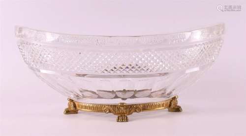 An oval clear crystal fruit bowl on a bronze base, 20th cent...