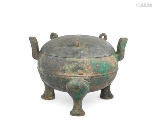 An archaic bronze tripod ritual food vessel and cover, ding