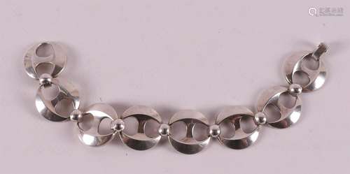 A first grade silver link bracelet with round openwork links...