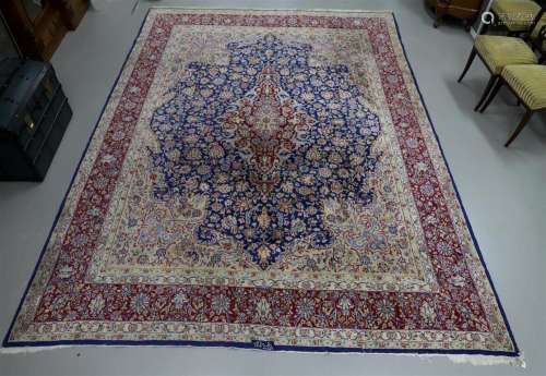 An oriental carpet, signed, 20th century.