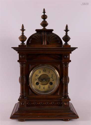 A table clock in walnut casing, Germany, Junghans, late 19th...