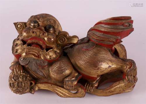A carved giltwood temple lion with flaming pearl, China, 19t...