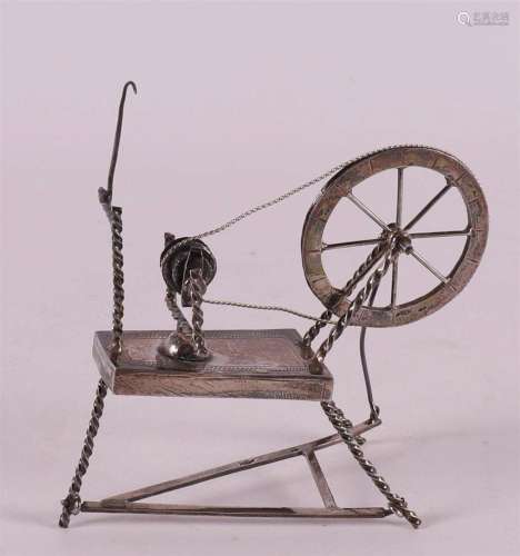 A 2nd grade silver miniature of a spinning wheel, B. Increas...