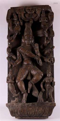 A carved wooden bas-relief of, among others, a multi-armed S...