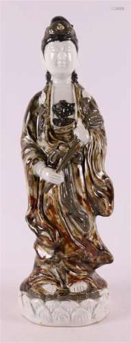 A white and brown glazed porcelain standing Kwan yin, Japan,...