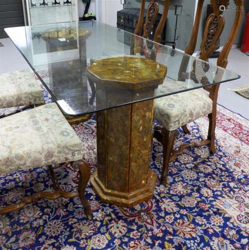 A rectangular table with clear glass top on a marble base, I...