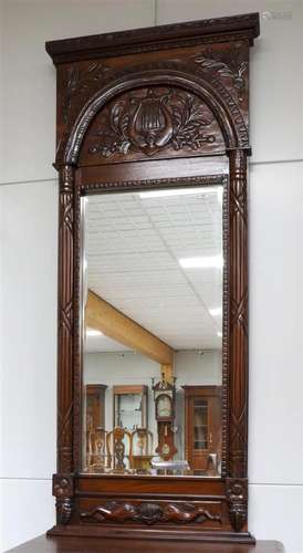 A rectangular faceted mirror in a walnut frame, 20th century...