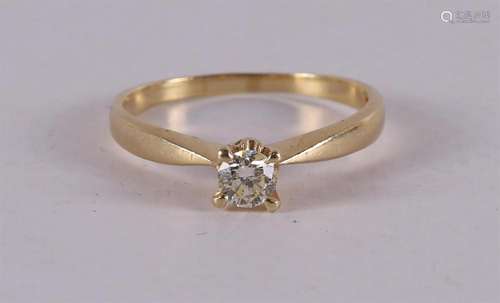 A 14 kt gold solitaire ring with a diamond.