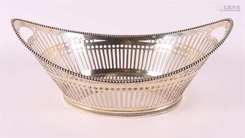 A silver boat-shaped bread basket with pearl rim, year lette...