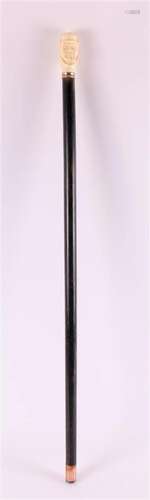 An ebonised wooden walking stick with carved ivory knob, Chi...