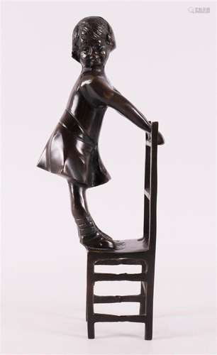 A brown patinated bronze girl on a chair, late 20th century