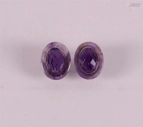 A pair of 1st grade silver oval ear studs with amethyst.