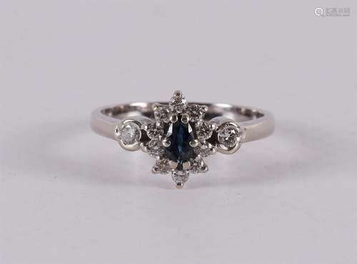 A 14 kt white gold ring with a facet cut marquise-shaped blu...