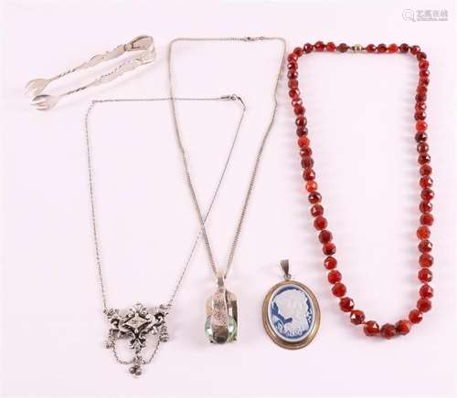 A lot of various jewelry, including a carnelian necklace.