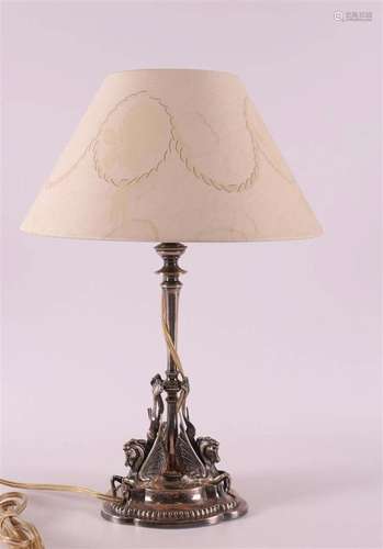 A silver-plated brass lamp base with a decoration of winged ...