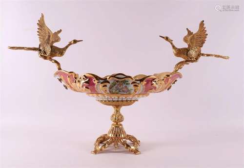 An oval polychrome earthenware fruit basket on a gilt base, ...