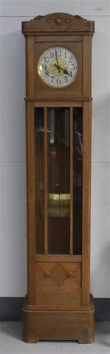 A grandfather clock in oak casing, ca. 1930.