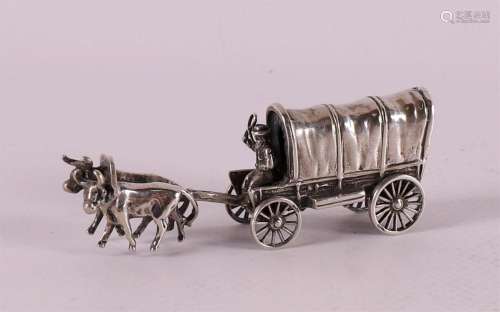 A 2nd grade silver miniature of a man in a covered wagon wit...