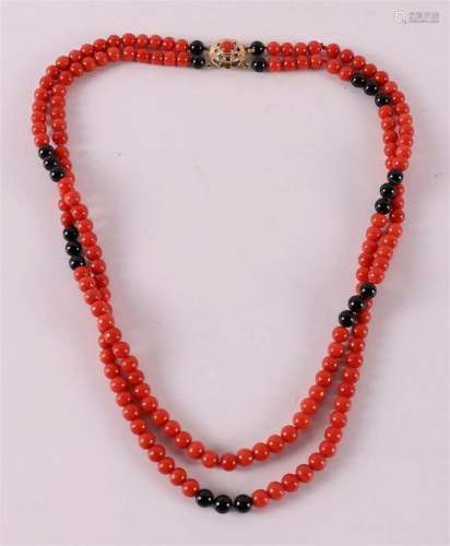 A two strand necklace of black beads and red coral, with a 1...