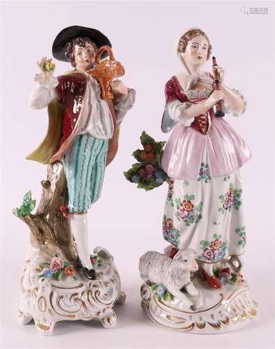 Two polychrome porcelain figures including a woman with a fl...