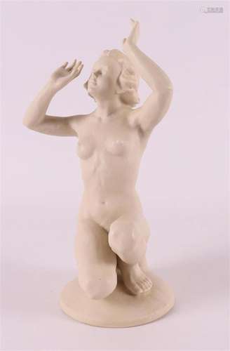 A bisquit porcelain kneeling female nude, Germany, 1940s.