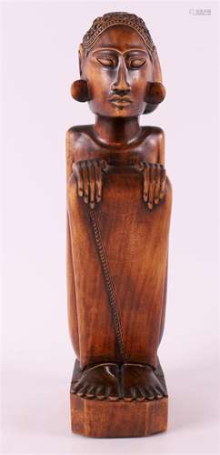 A wooden Art Deco sculpture of a crouching man, Indonesia, B...