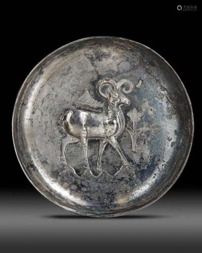 A SILVER DISH WITH THE IMAGE OF A RAM, LATE SASSANIAN OR EAR...