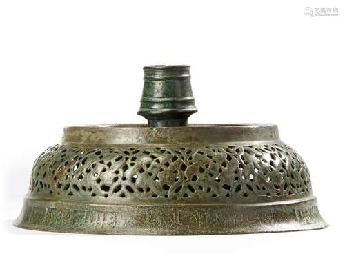 AN INSCRIBED KHORASAN OPENWORK, BRONZE CANDLESTICK BASE, PER...