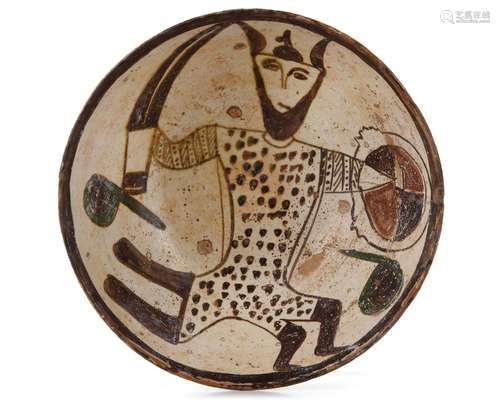 A NISHAPUR FIGURAL BUFFWARE POTTERY BOWL DEPICTING A WARRIOR...