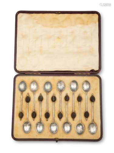 A Cased Set of English Silver Coffee Spoons with Treen Handl...