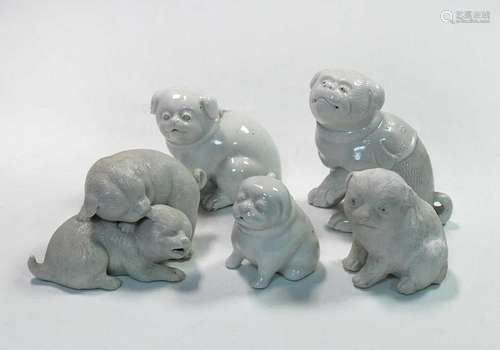 A group of five Japanese porcelain puppy and puppy groups, 1...