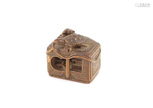 A Japanese boxwood netsuke of a minogame and young perched o...