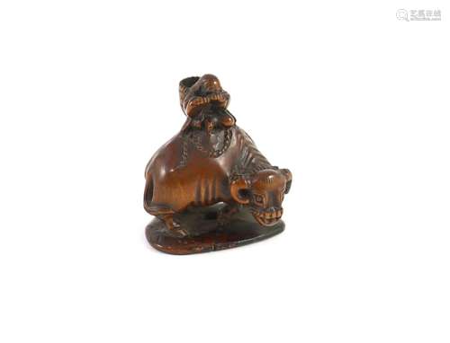 A Japanese boxwood netsuke of Semimaru playing the flute and...