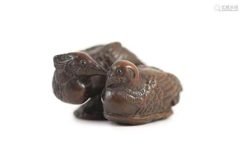 A Japanese wood netsuke of a male and female mandarin duck (...