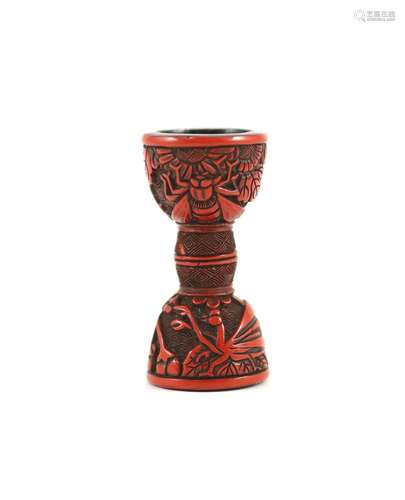 A Japanese red lacquer netsuke in the form of a hand drum (t...