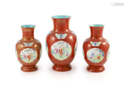 A set of three Chinese coral ground ‘boys’ vases, Jiaqing pe...