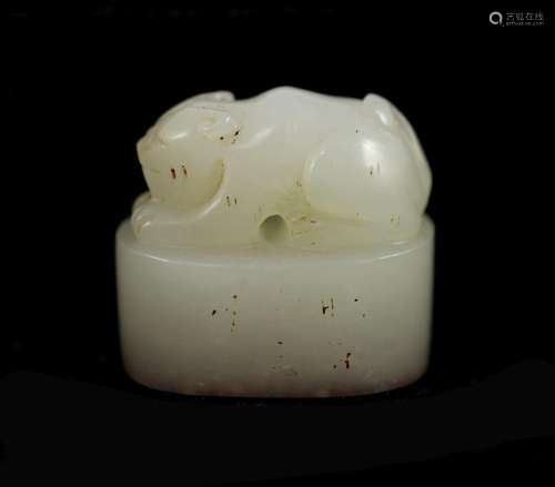 A Chinese white jade and oval 'crouching cat' seal...