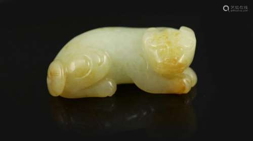 A Chinese pale celadon and russet jade figure of a lion dog,...