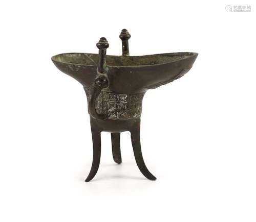 A Chinese archaistic bronze ritual tripod wine vessel, jue, ...