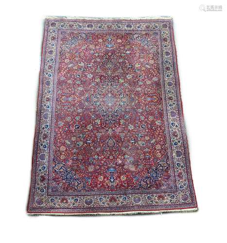 A Tabriz red ground carpet with, first half 20th century, 51...