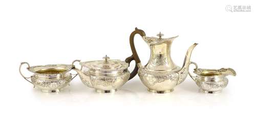 An Edwardian embossed silver circular four piece tea and cof...