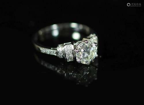 A modern platinum and single stone diamond ring centre with ...