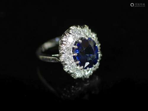 A modern 18ct white gold, sapphire and diamond set oval clus...