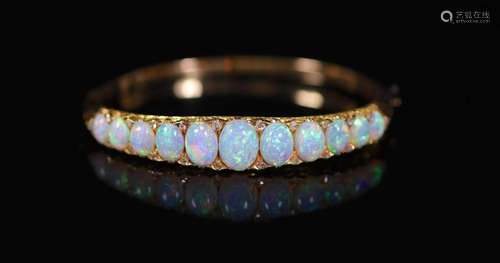 An Edwardian gold and graduated eleven stone white opal set ...