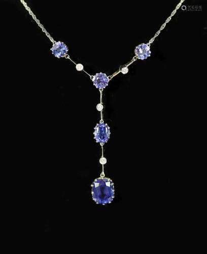 A modern platinum, five stone tanzanite and four small round...