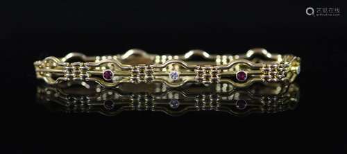 An Edwardian 15ct gold, three stone ruby and two stone diamo...