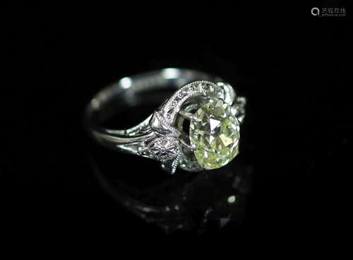 A white gold and oval cut solitaire diamond ring, in a raise...