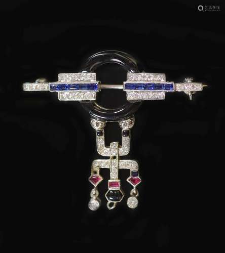 An Art Deco white gold, black enamel, ruby, sapphire and dia...